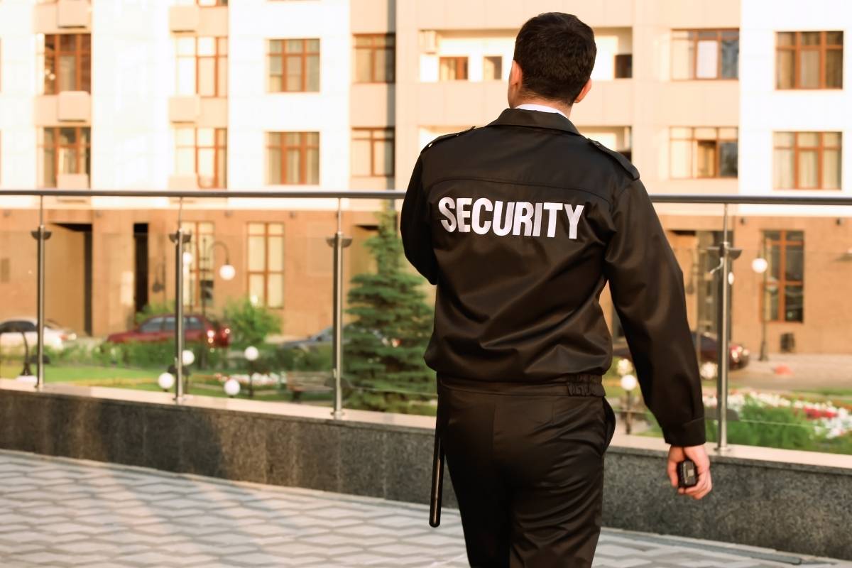 Security guard standing outside hotel lobby