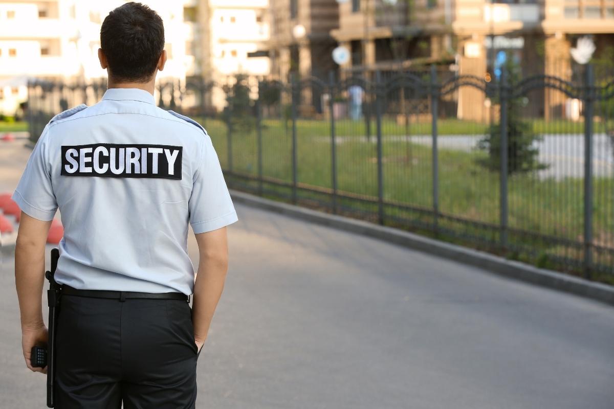 Unarmed security guard outside commercial building