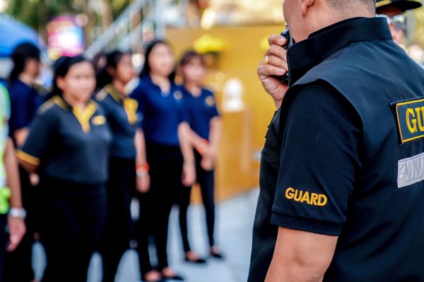 Head security guard assessing the area during an emergency.