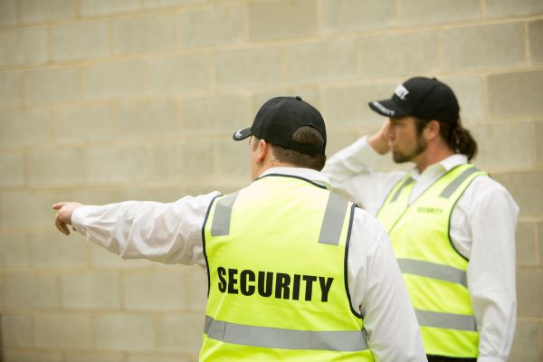 Security guard instructing a colleague.