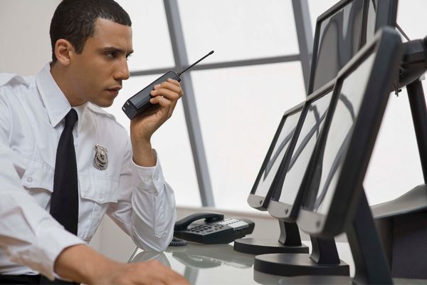 Shopping center guard monitoring security cameras