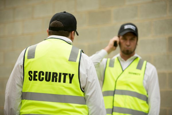 Security guard speaking to a colleague.
