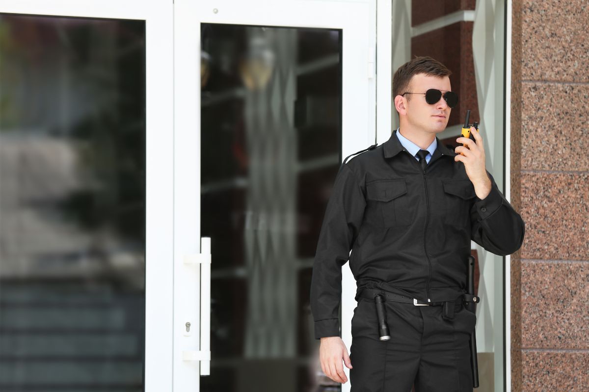 Armed security officer standing guard in front of a building