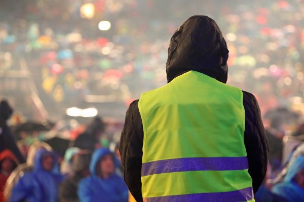 A security officer keeps the crowd organized.
